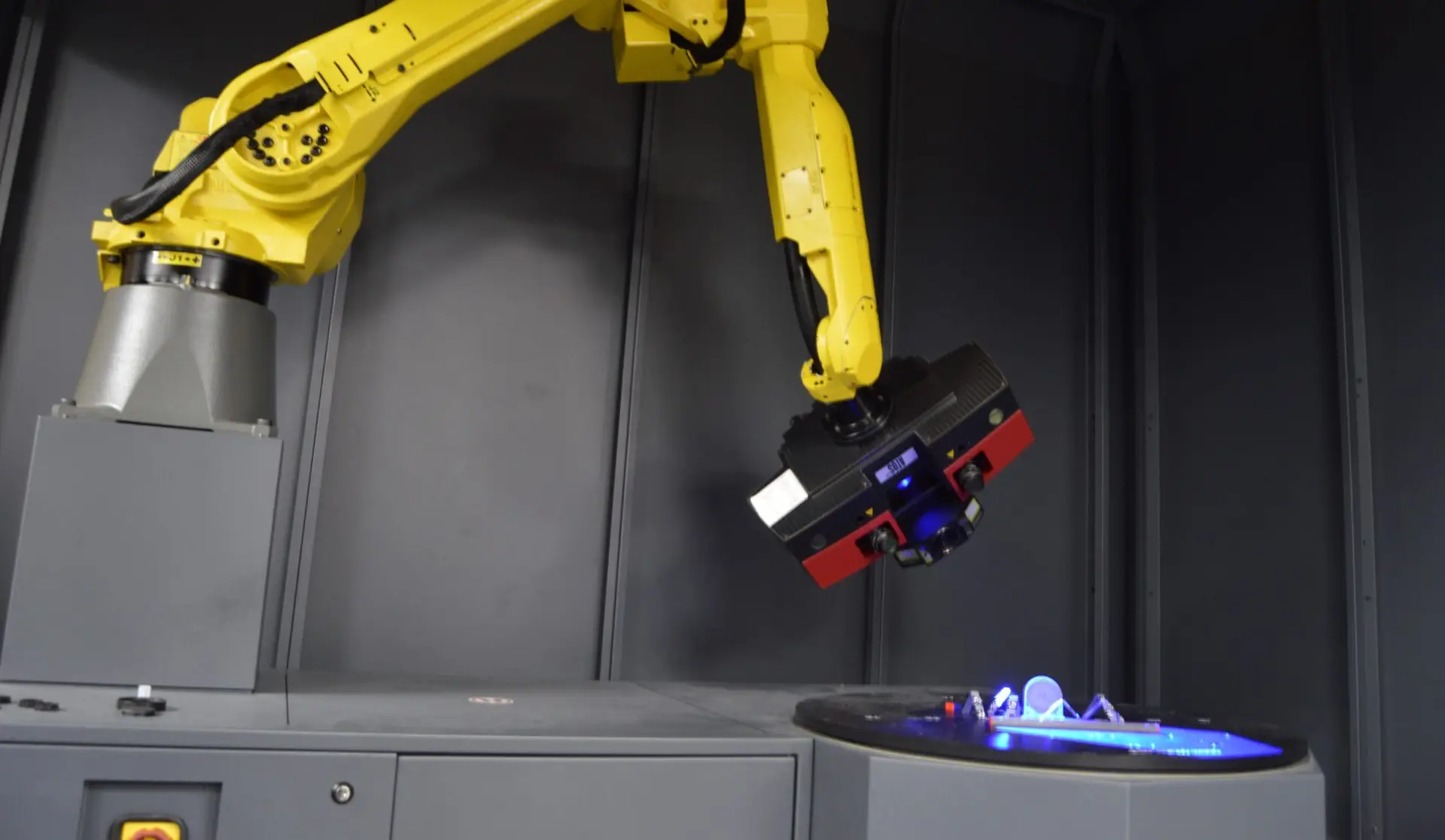 Robotic ATOS structured light scanner performing automated 3D dimensional inspection.
